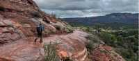 Hiking across exposed slickrock, smooth sandstone common on Sedona’s trails
